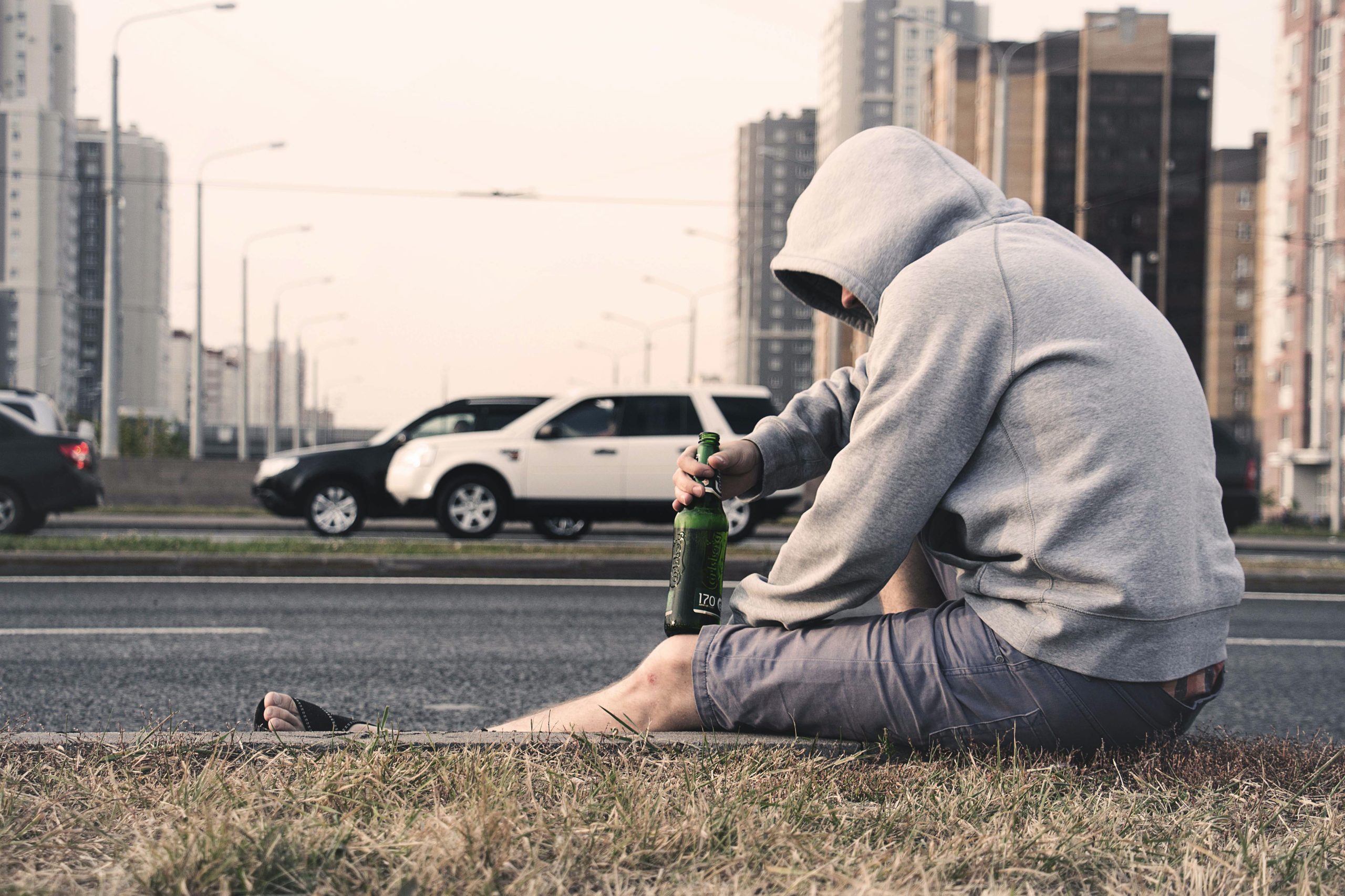 man drinking outside