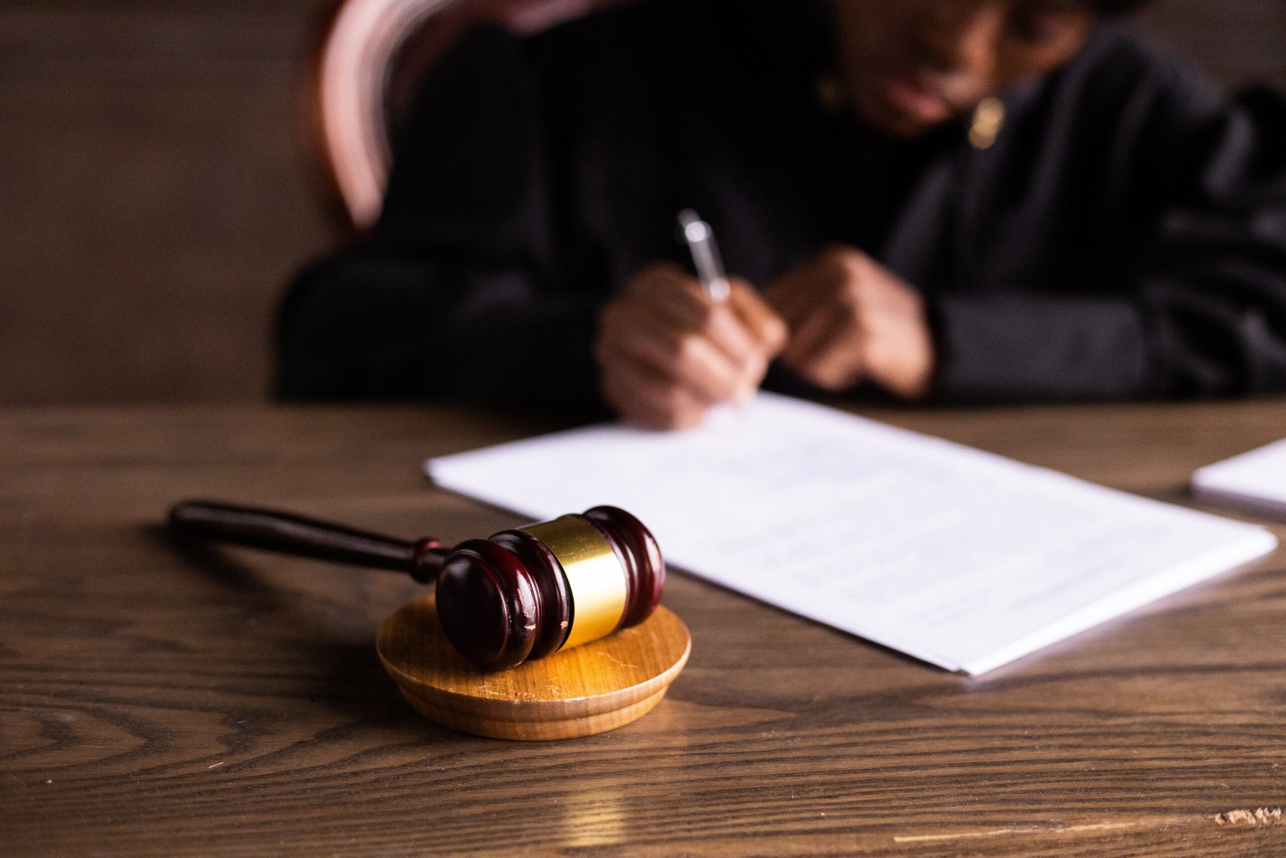 judge writing behind desk