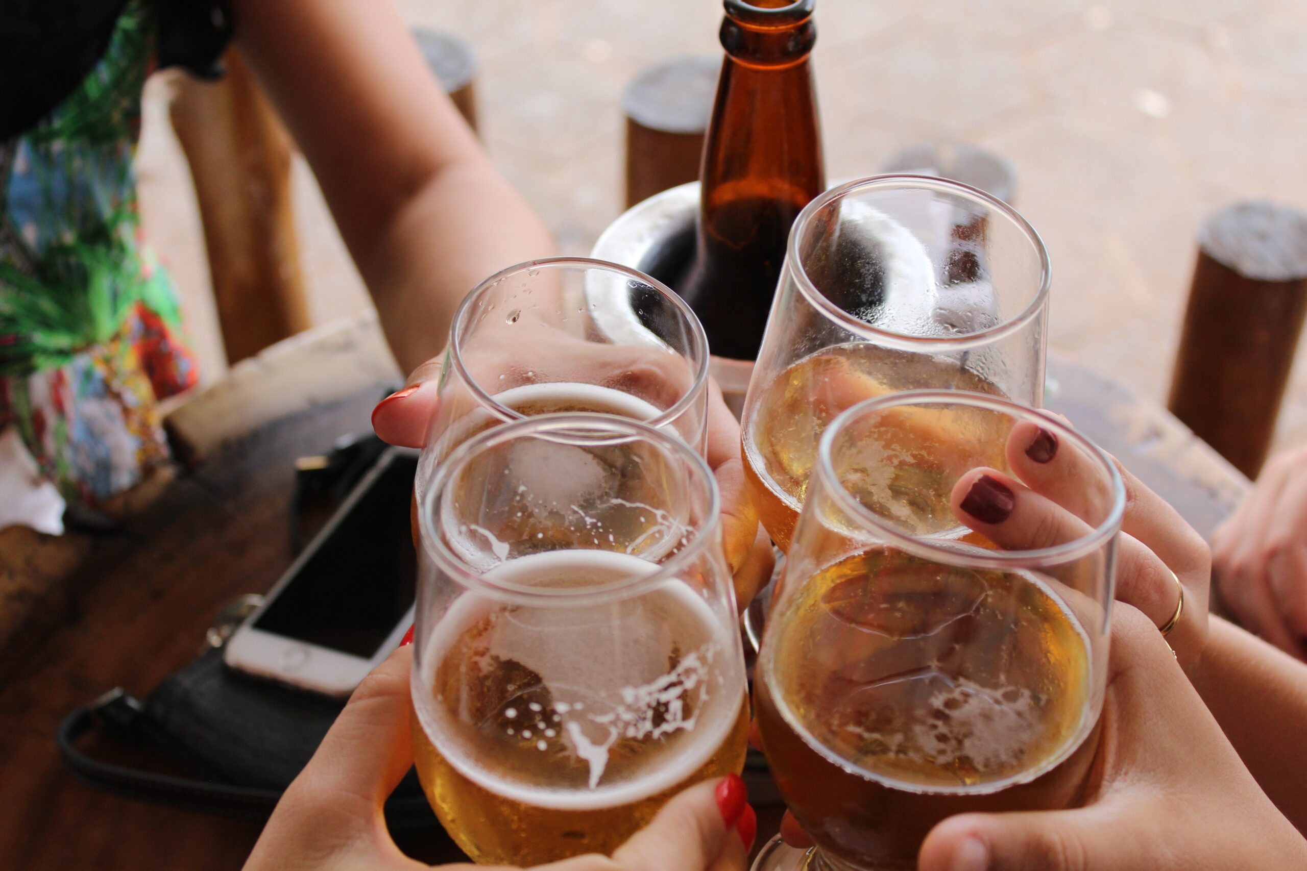 people doing a toast with beer glasses