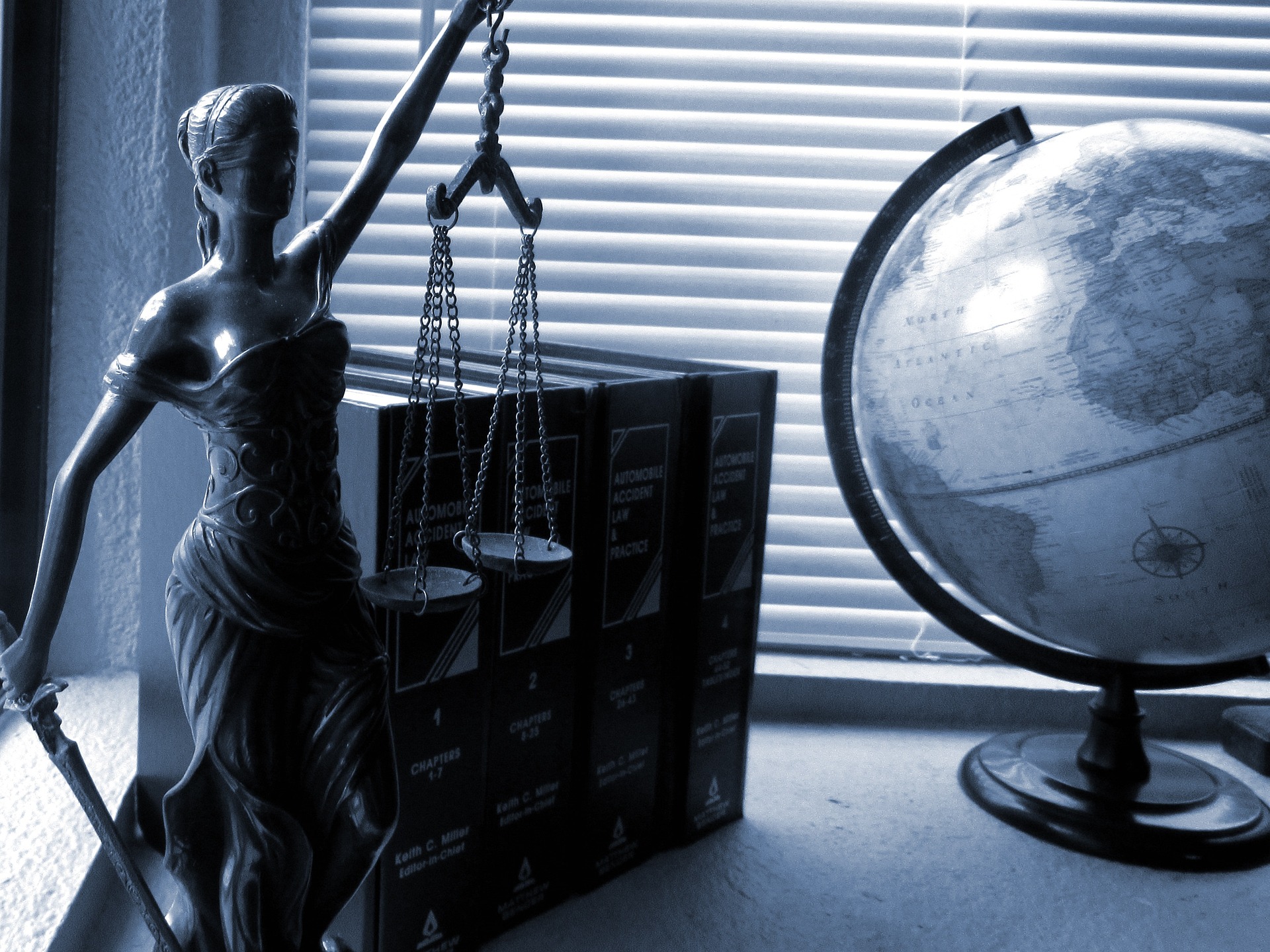 lady of justice statue on lawyer's desk