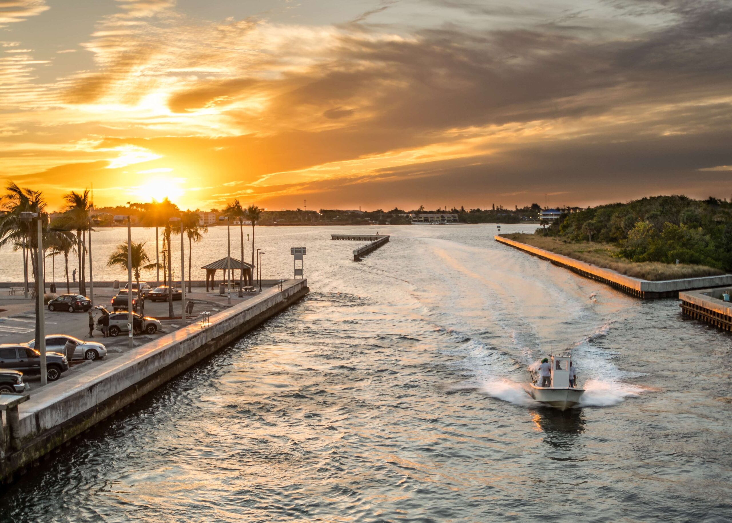 boat returning to dock in florida while the sun is setting