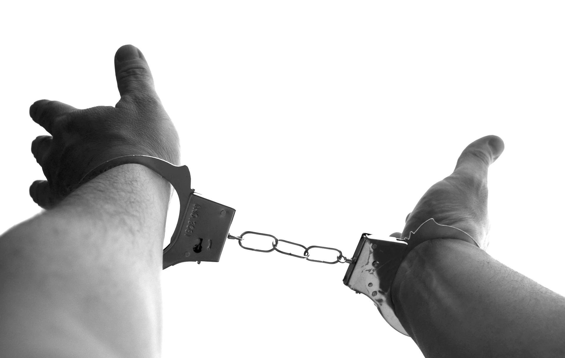 person bound in handcuffs