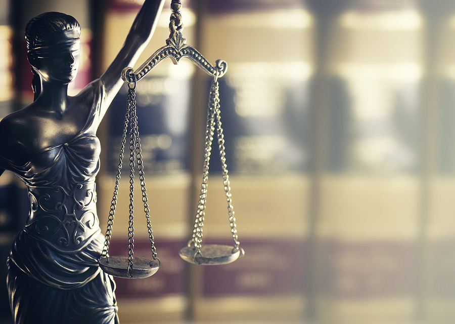Burden of proof - Moodily lit legal law concept image with Scale