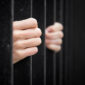 Prisoner behind jail bars