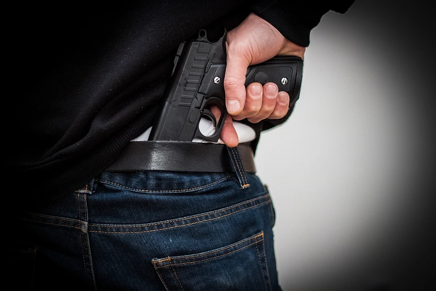 Person taking gun from holster
