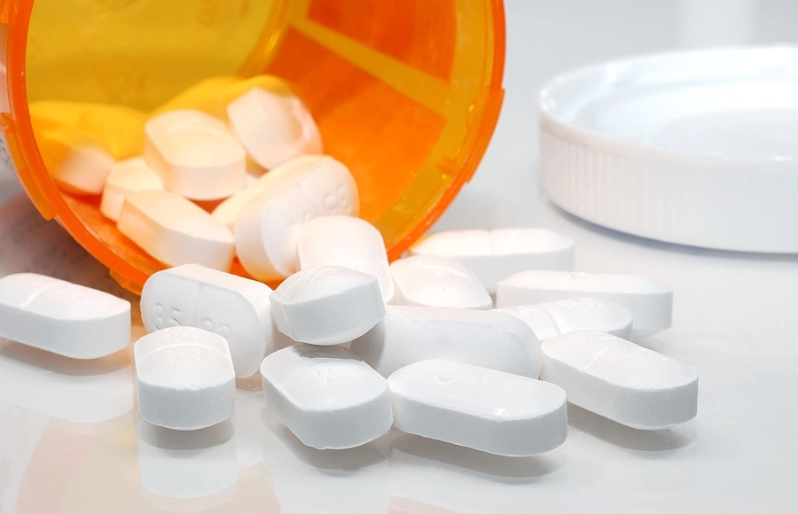 White-pills-spilling-out-of-bottle